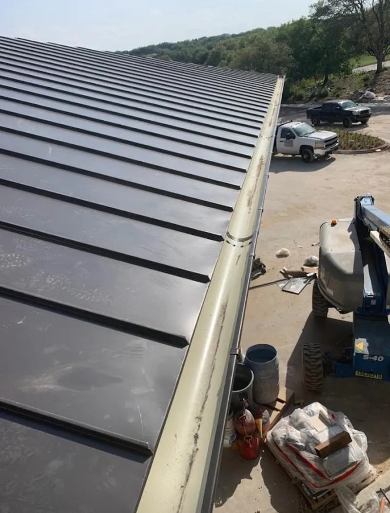 Standing seam panel and gutter detail on a metal roofing jobsite in White Center